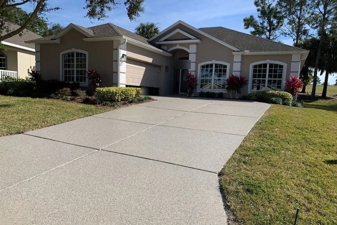 Residential driveway with a sand-tone flake coating and saw-cut joints