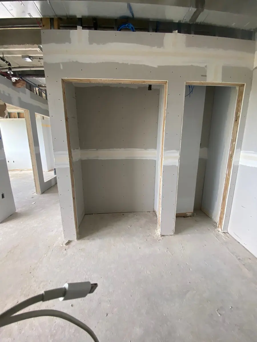 New drywall closet openings framed and taped in a commercial build-out