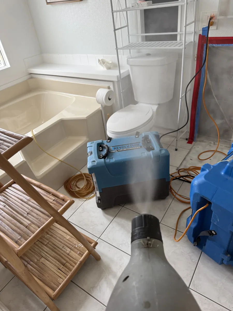 Antimicrobial treatment being applied with a fogger inside the contained bathroom